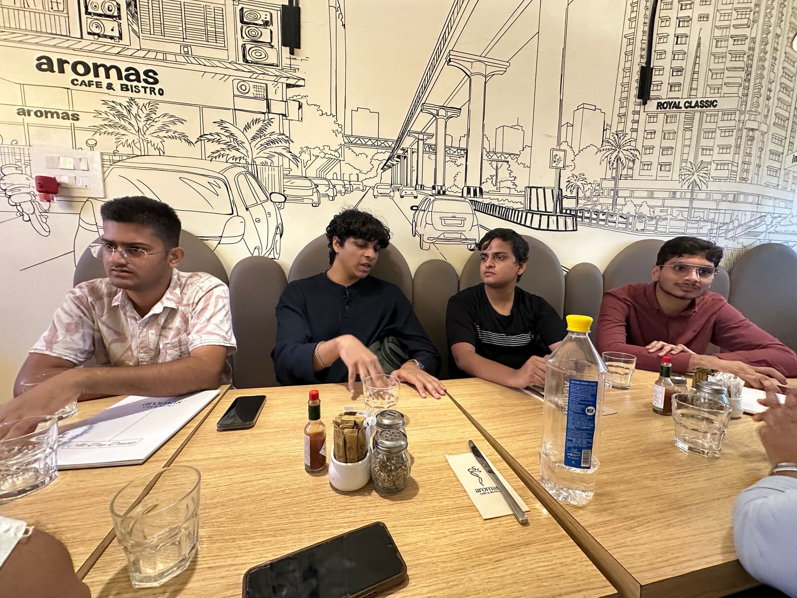 Founders deep in a booth conversation, mid-pitch energy